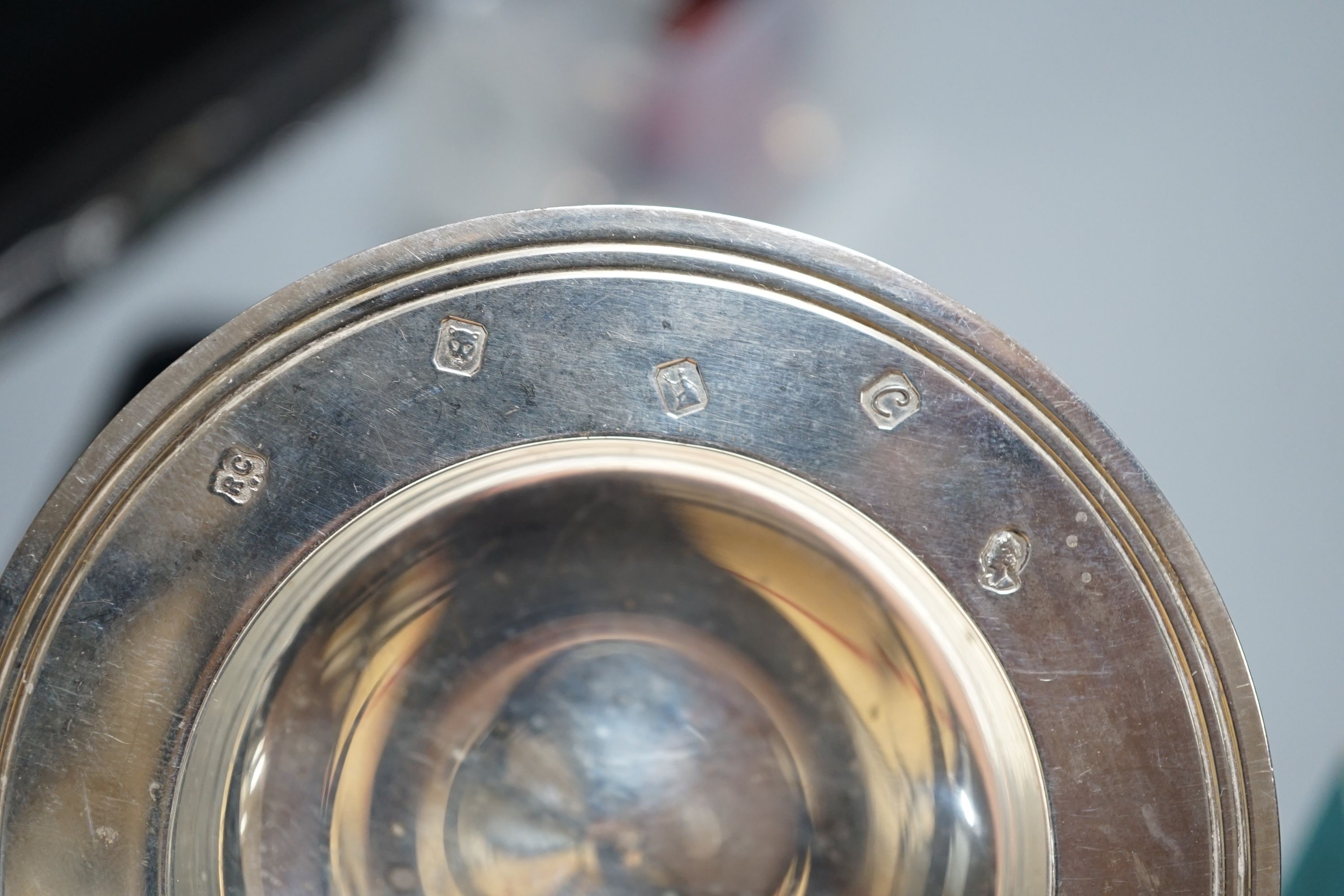 A late Victorian silver mustard, Sheffield, 1895, two small silver armada dishes, a silver bonbon dish, silver tea strainer(a.f.) and a silver mounted glass toilet jar.